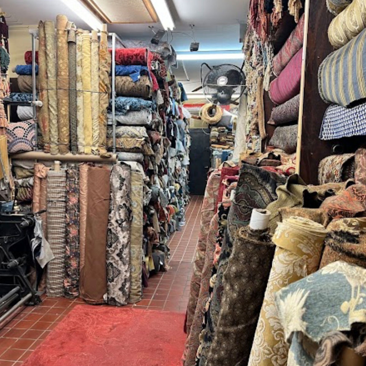 Fabric rolls and decorative trim lining an aisle inside Fabric City