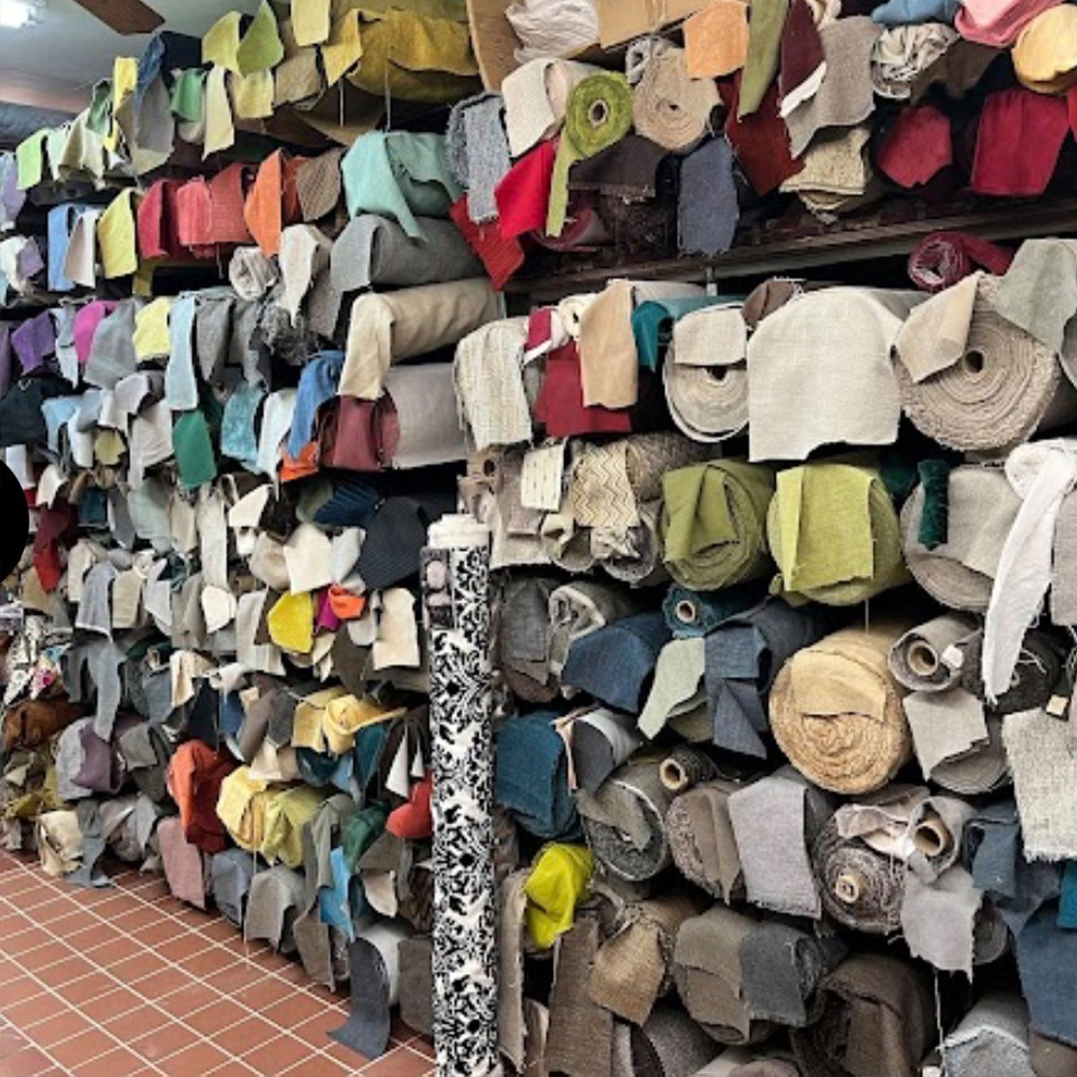 Wall of colorful upholstery fabric remnants inside Fabric City