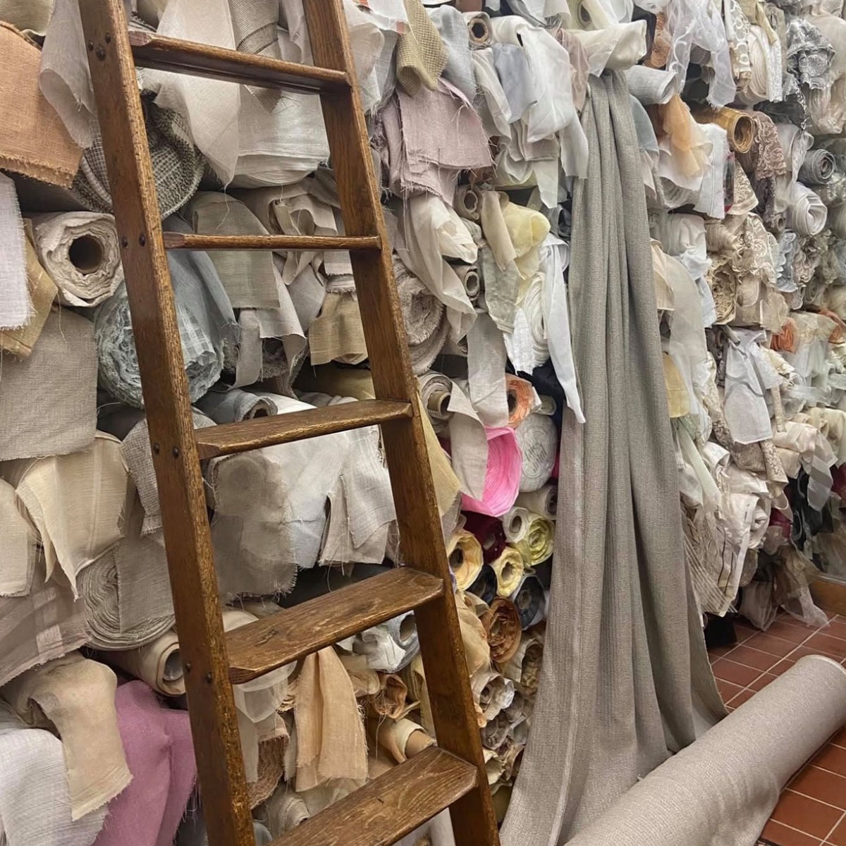 Fabric rolls and decorative trim lining an aisle inside Fabric City